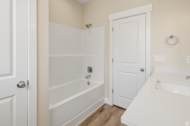 157 West 100 South Joseph, UT 84739 - Photo 22 of 30 Bathroom with vanity, light wood finished floors, and washtub / shower combination