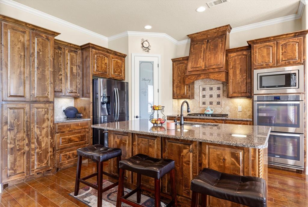 104 Rattling Antler Court Azle, TX 76020 - Photo 5 of 38 Beautiful knotty alder cabinetry.