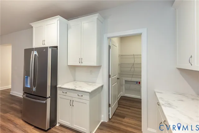 a kitchen with a refrigerator sink and cabinets