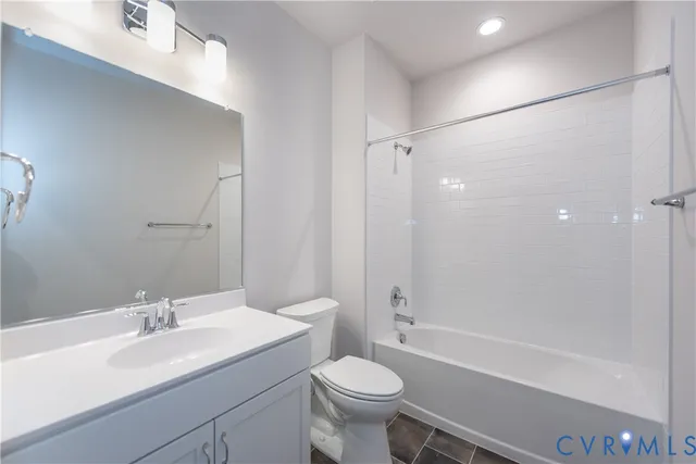 a bathroom with a sink toilet vanity and shower