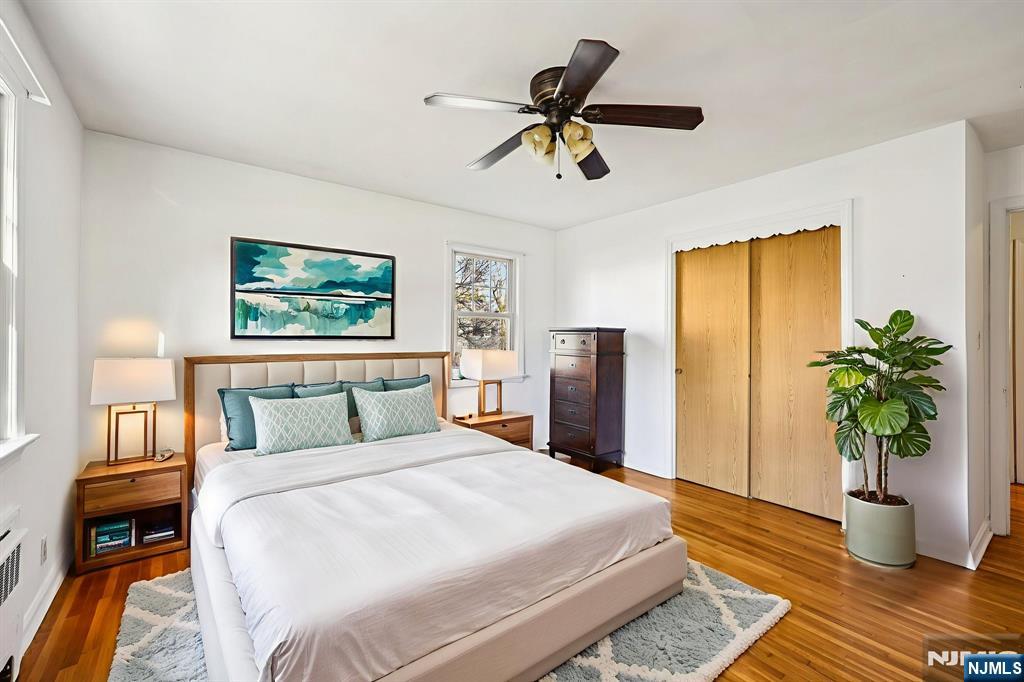 190 Bell Street Belleville, NJ 07109 - Photo 12 of 21 a bedroom with a large bed and a chandelier