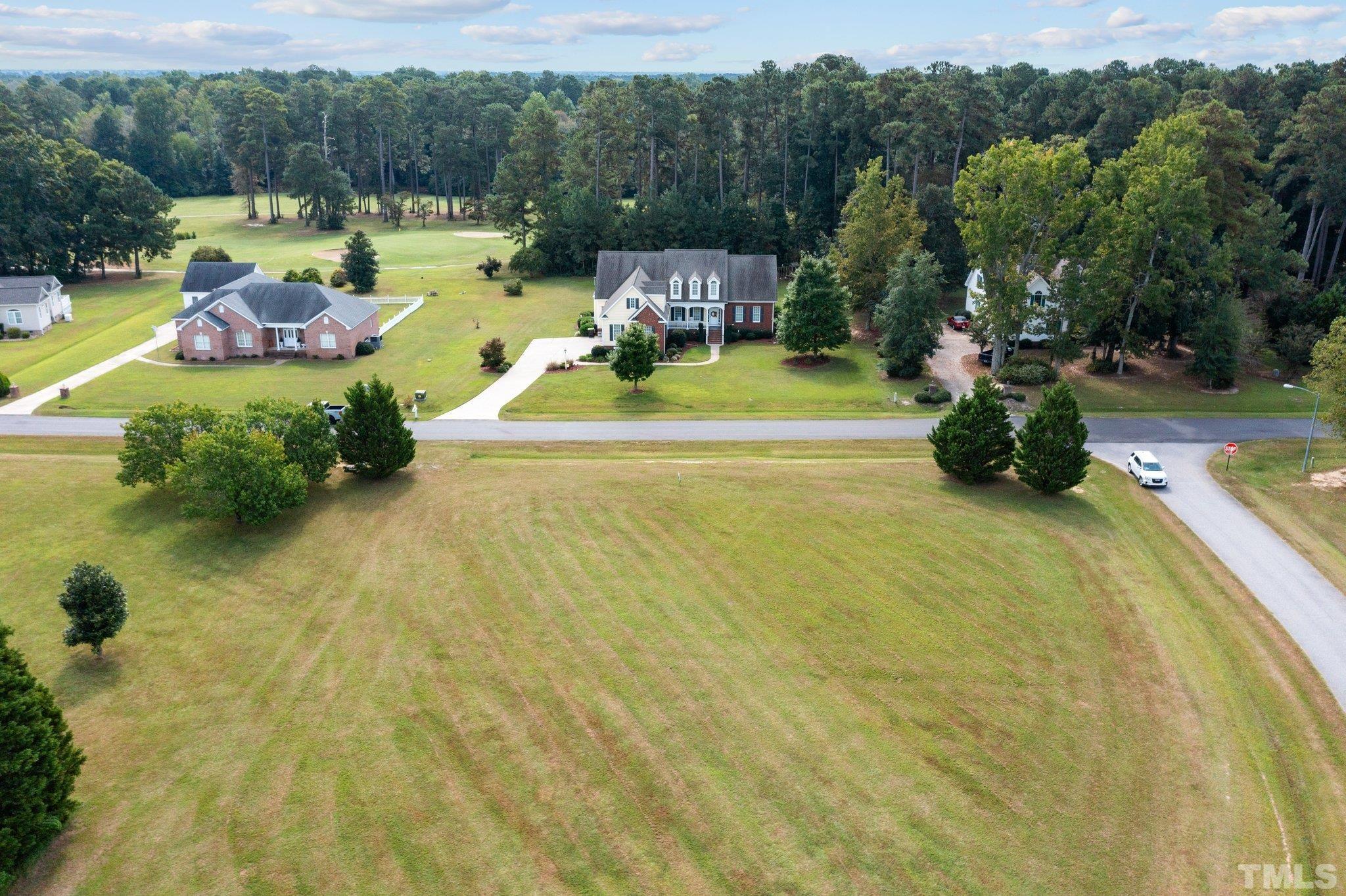 84 Golf Course Drive Pinetops, NC 27864 - Photo 14 of 38 a view of a swimming pool and lounge chair