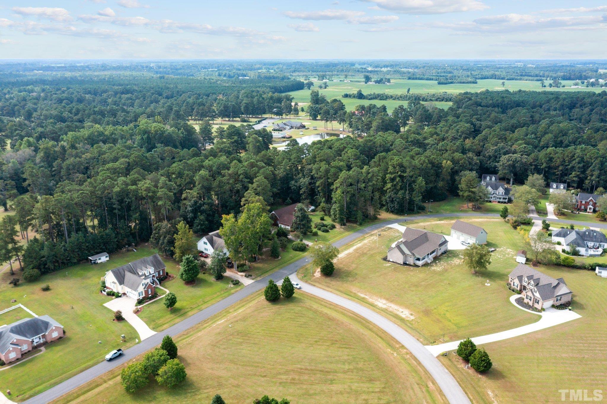 84 Golf Course Drive Pinetops, NC 27864 - Photo 15 of 38 an aerial view of a swimming pool and mountain view