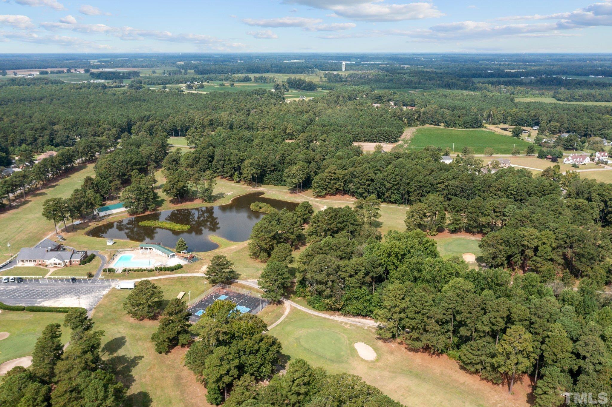 84 Golf Course Drive Pinetops, NC 27864 - Photo 23 of 38 a view of a lake with a city