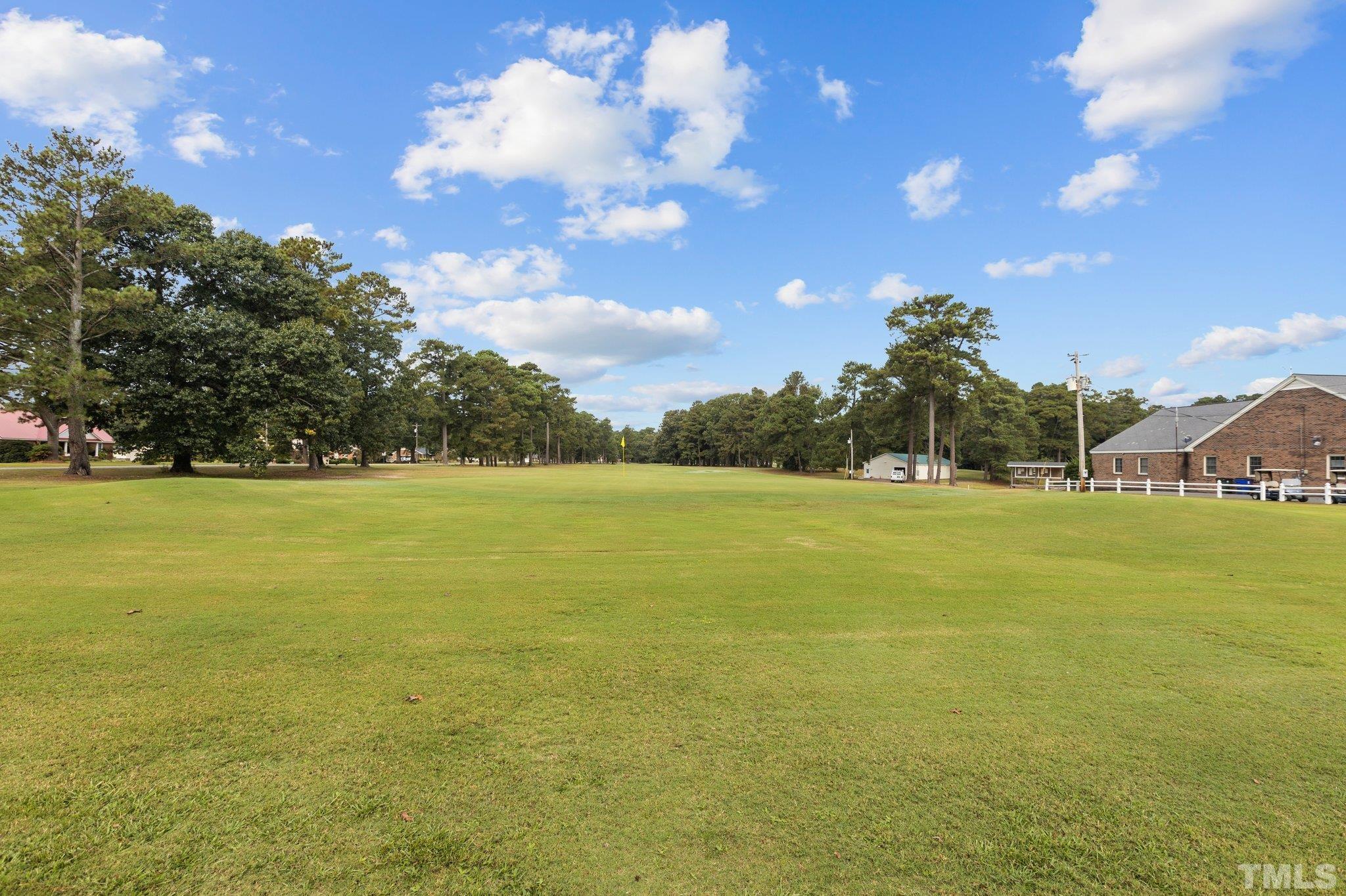 84 Golf Course Drive Pinetops, NC 27864 - Photo 24 of 38 a view of outdoor space with playground and lots of green space