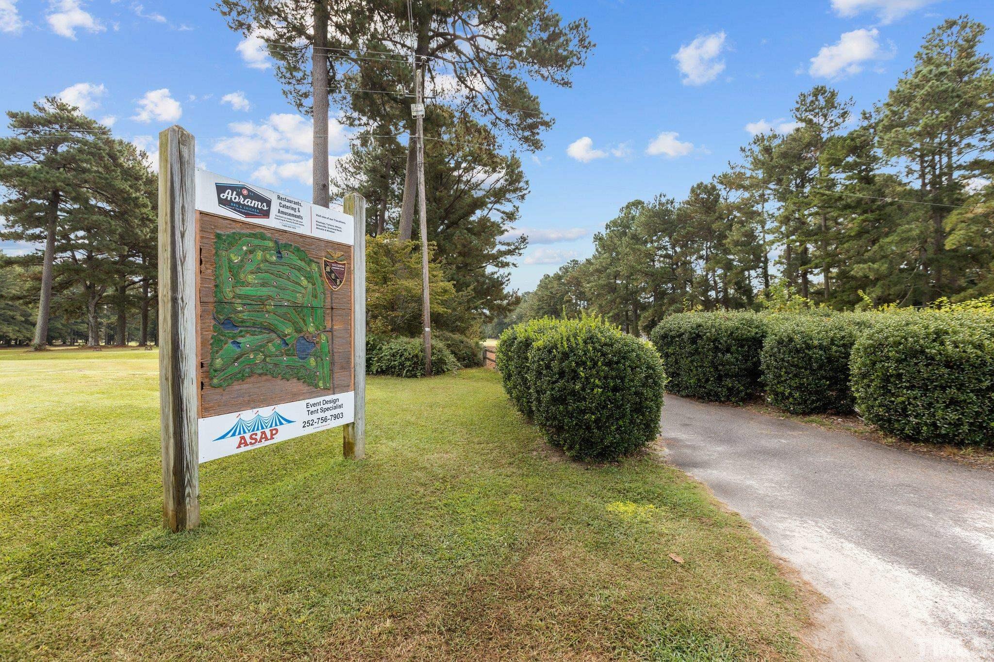 84 Golf Course Drive Pinetops, NC 27864 - Photo 29 of 38 a view of a garden with large trees