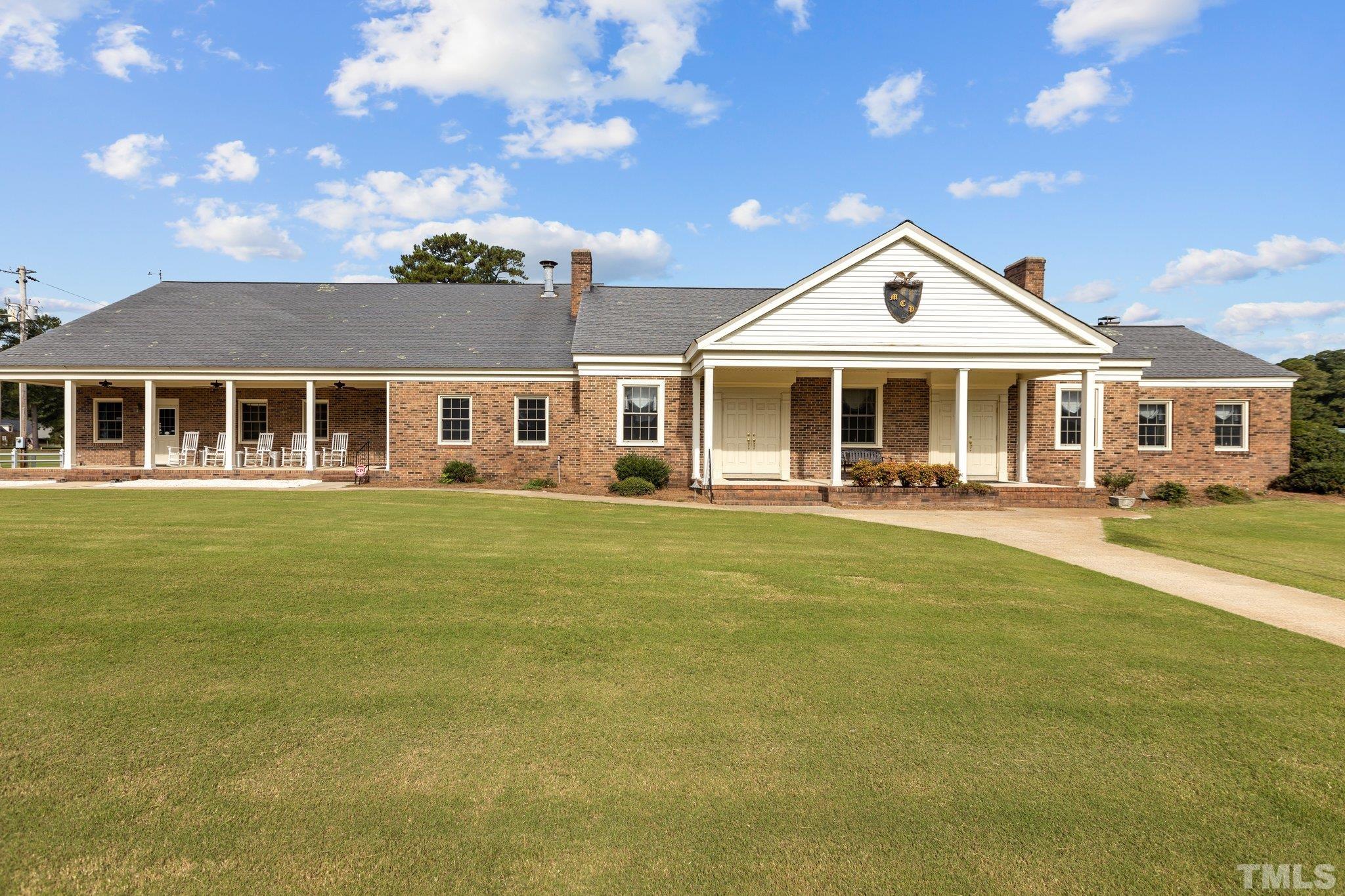 84 Golf Course Drive Pinetops, NC 27864 - Photo 30 of 38 a front view of a house with a garden