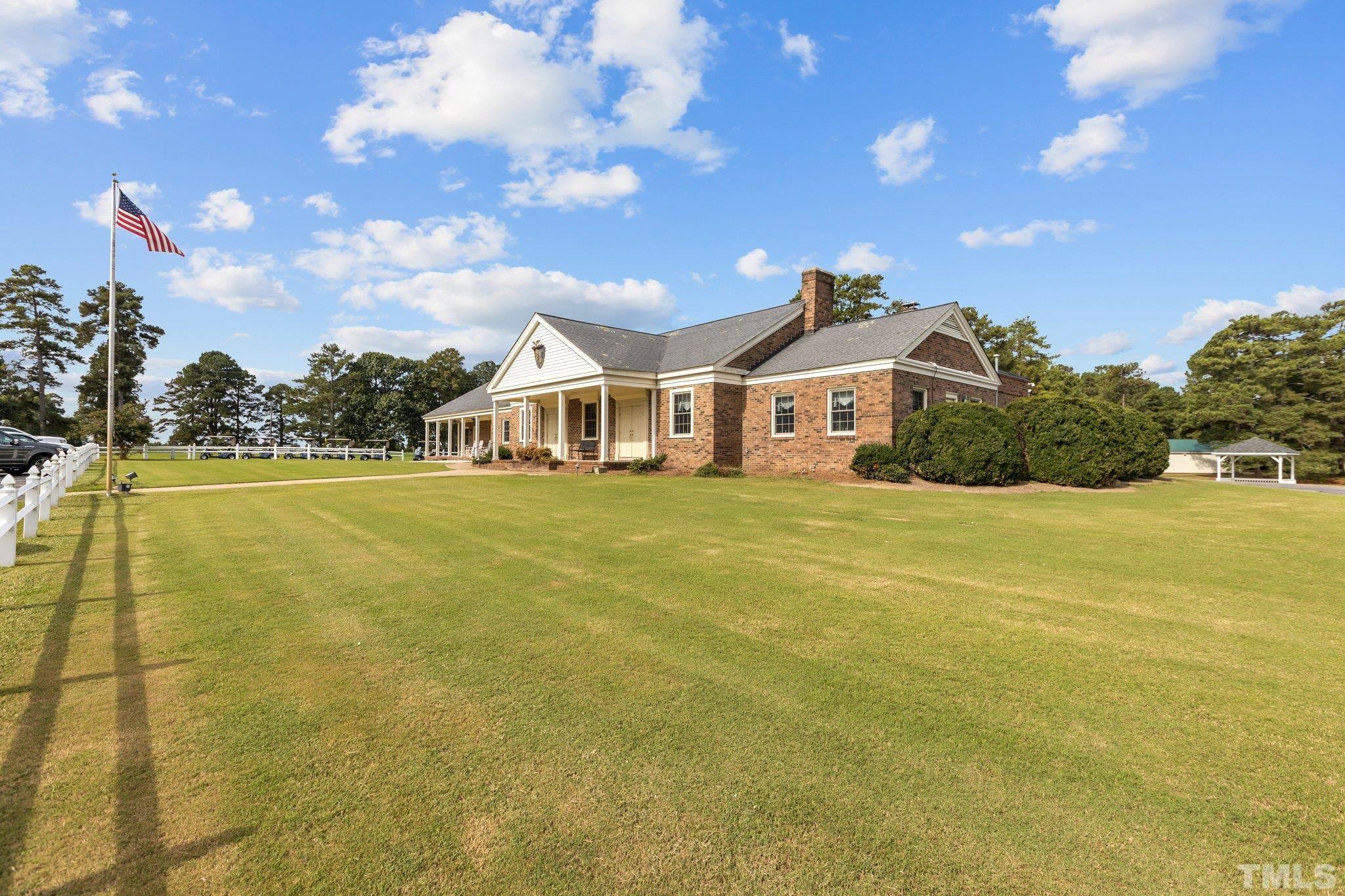 84 Golf Course Drive Pinetops, NC 27864 - Photo 32 of 38 a front view of a house with a big yard