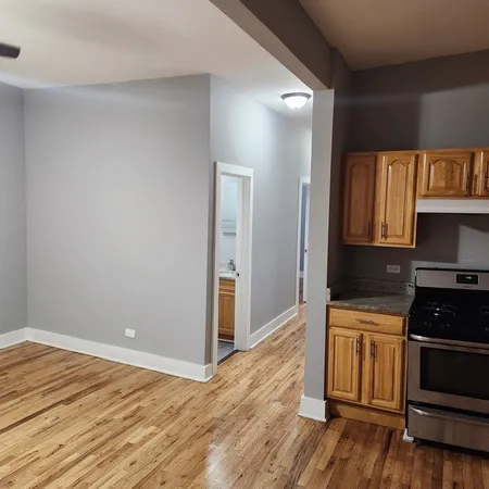 a kitchen with granite countertop wooden floors and black appliances