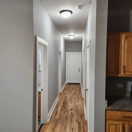 a view of hallway with wooden floor
