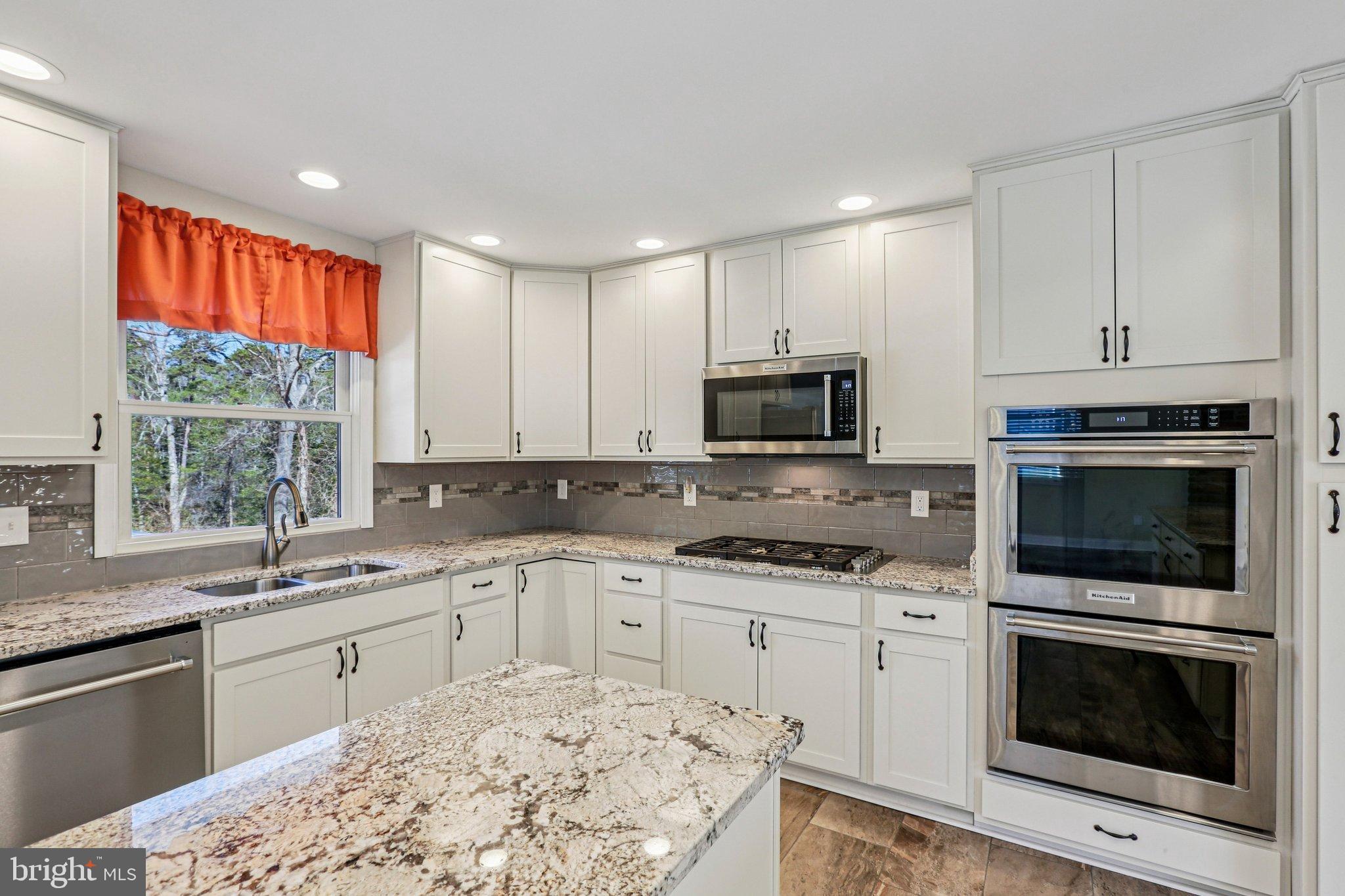 306 Christy Road Pasadena, MD 21122 - Photo 11 of 58 a kitchen with a sink stove and microwave