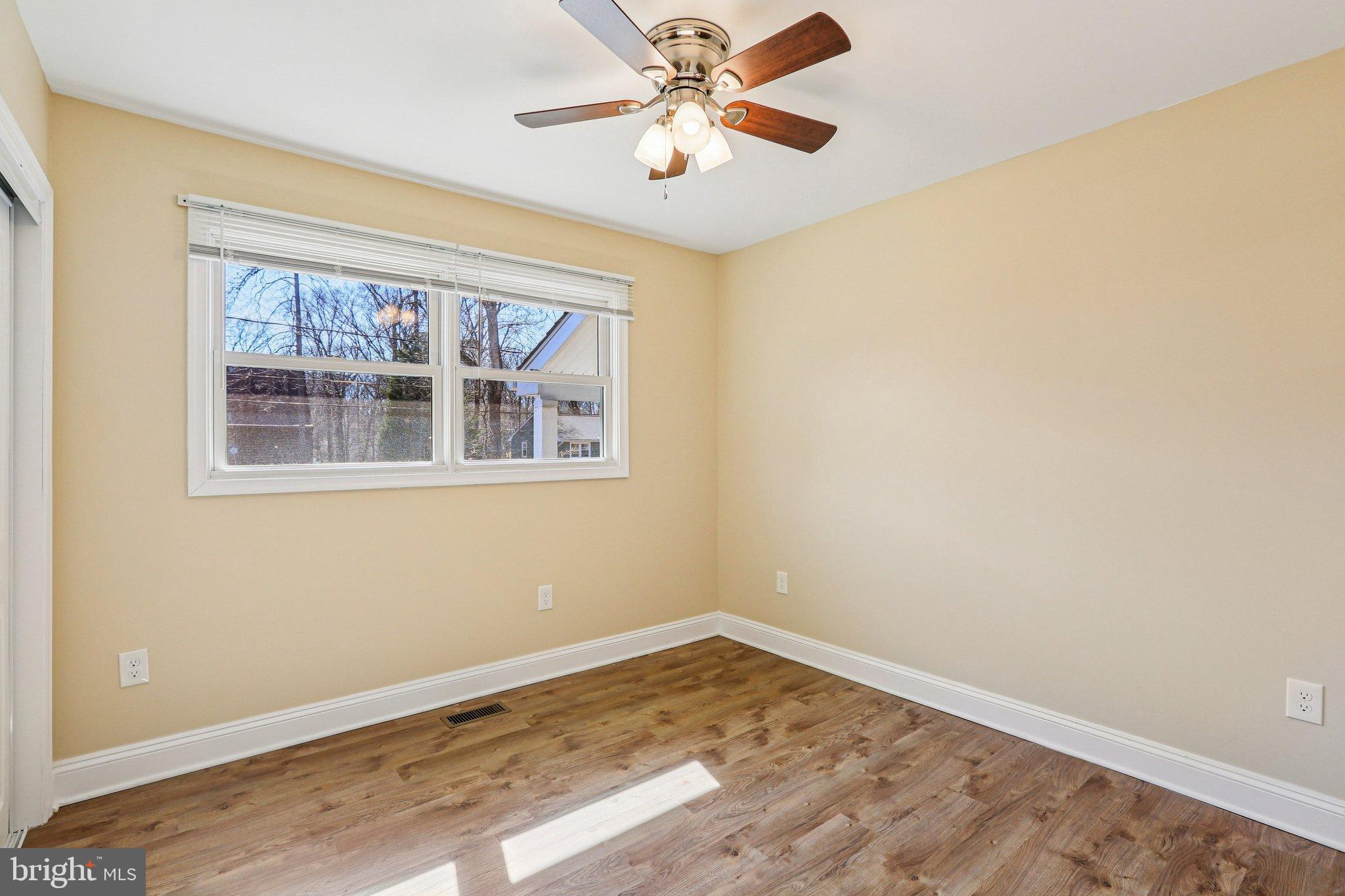 306 Christy Road Pasadena, MD 21122 - Photo 13 of 58 a view of empty room with wooden floor and fan