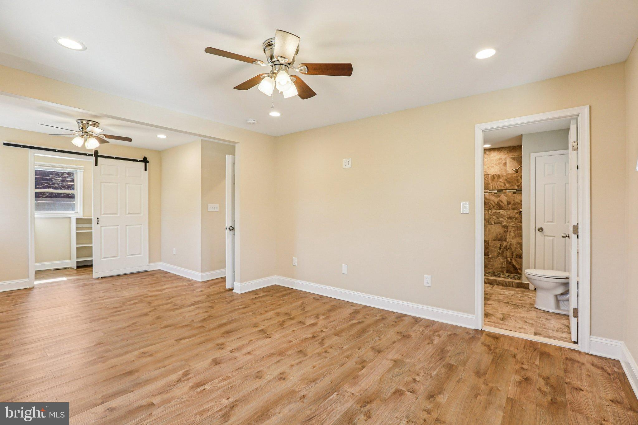 306 Christy Road Pasadena, MD 21122 - Photo 17 of 58 wooden floor in an empty room with a window