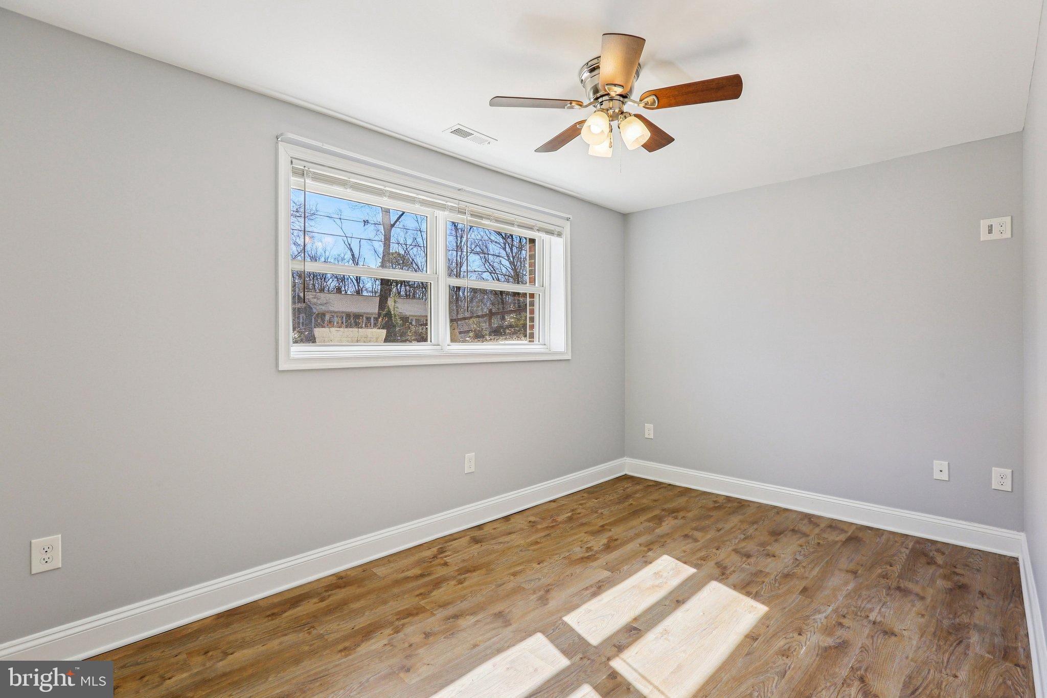 306 Christy Road Pasadena, MD 21122 - Photo 19 of 58 a view of a big room with wooden floor and a window