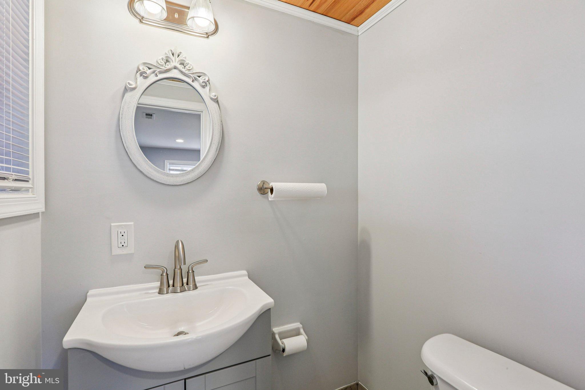 306 Christy Road Pasadena, MD 21122 - Photo 23 of 58 a bathroom with a toilet and a sink