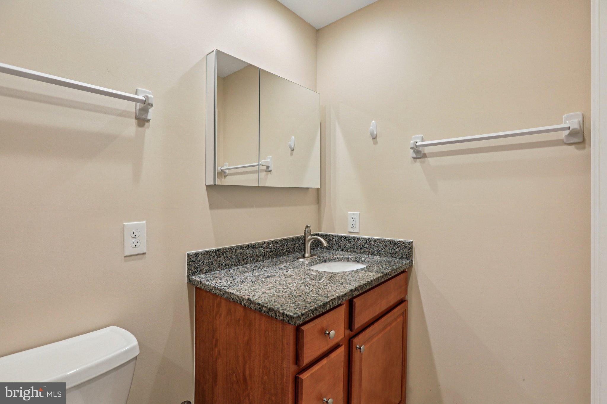 306 Christy Road Pasadena, MD 21122 - Photo 25 of 58 a utility room with granite countertop a sink and toilet