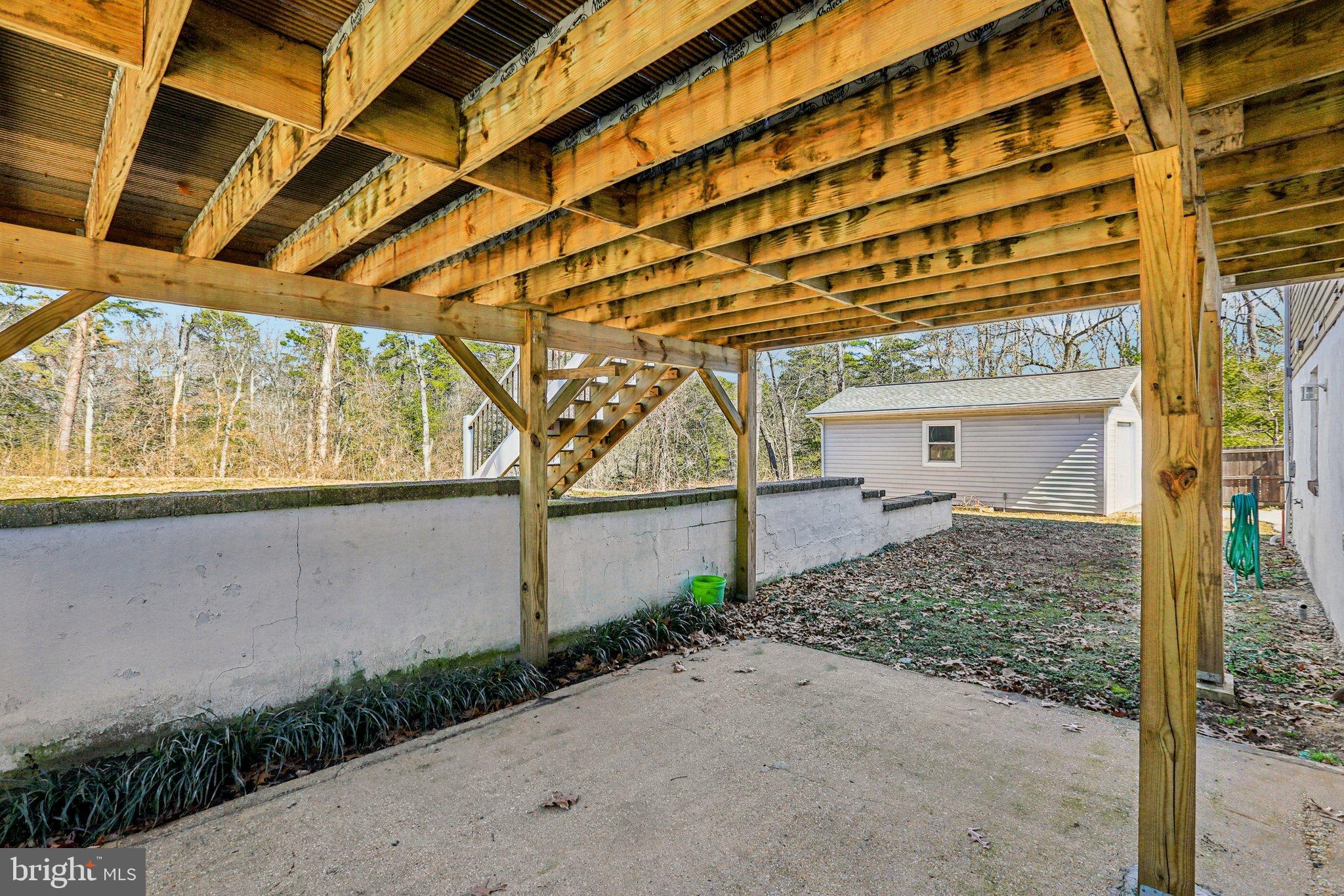 306 Christy Road Pasadena, MD 21122 - Photo 34 of 58 Inviting outdoor space beneath a wooden deck.