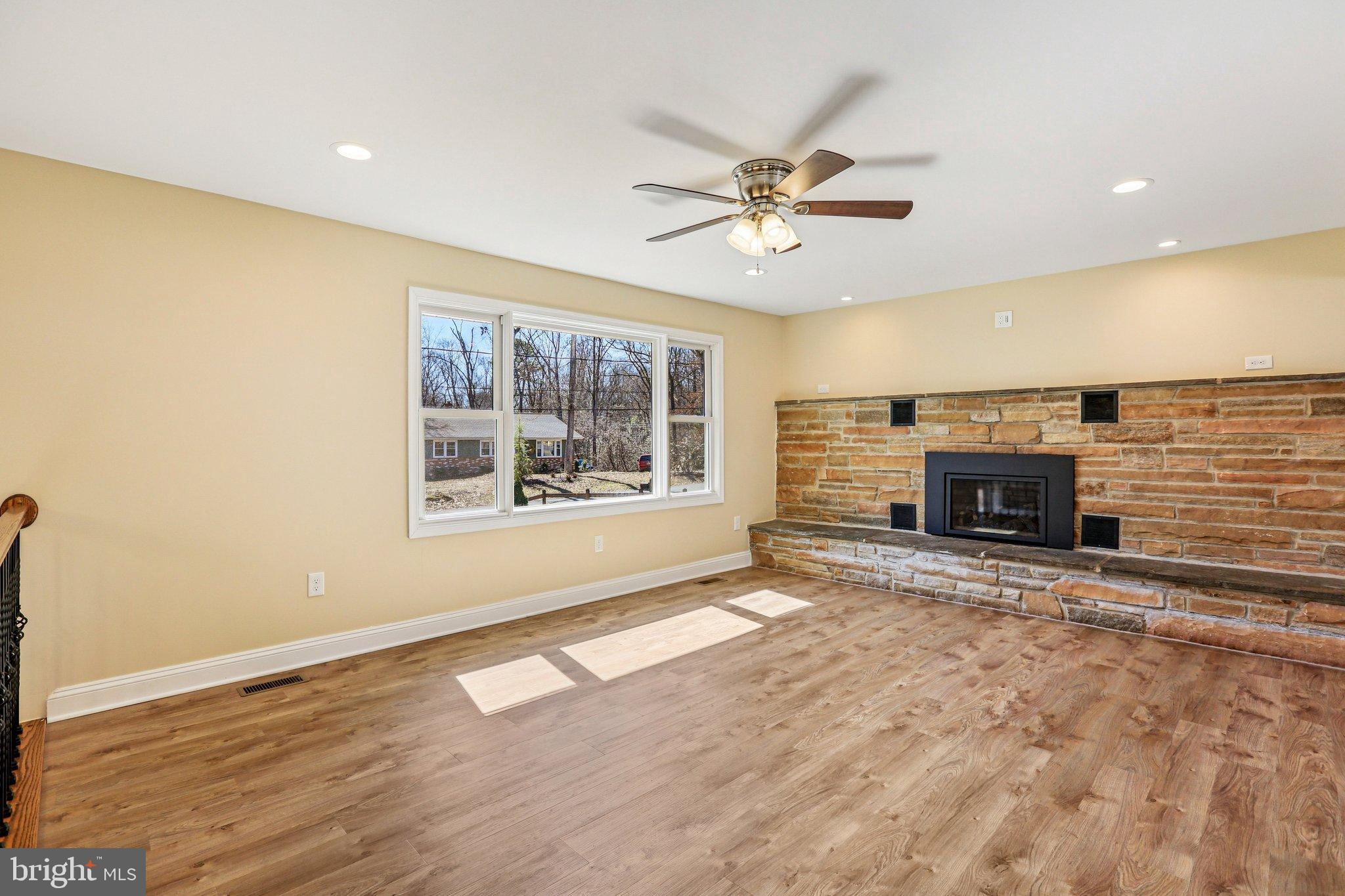 306 Christy Road Pasadena, MD 21122 - Photo 4 of 58 a view of an empty room with a window and fireplace