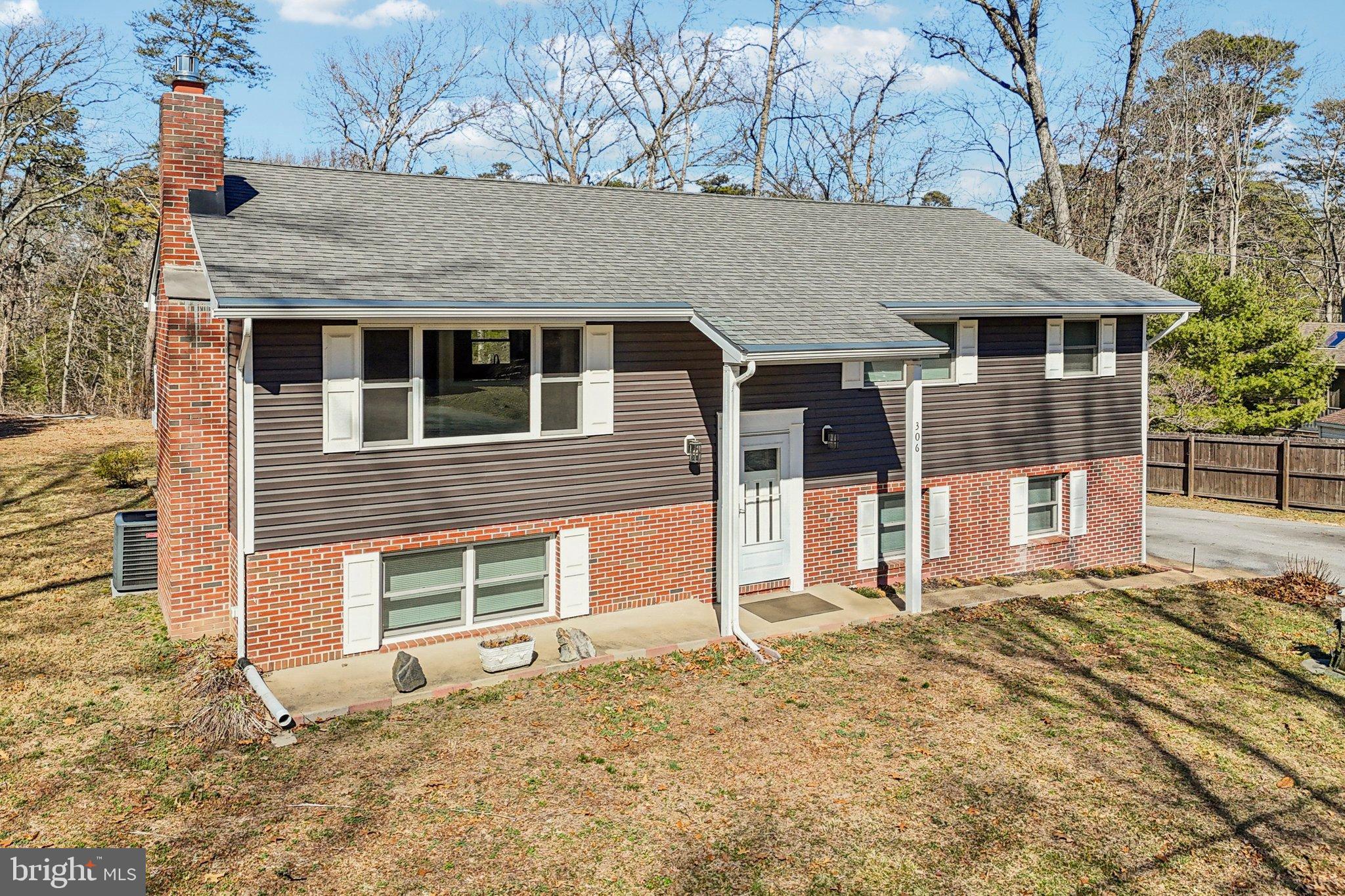 306 Christy Road Pasadena, MD 21122 - Photo 42 of 58 front view of a house with a large yard