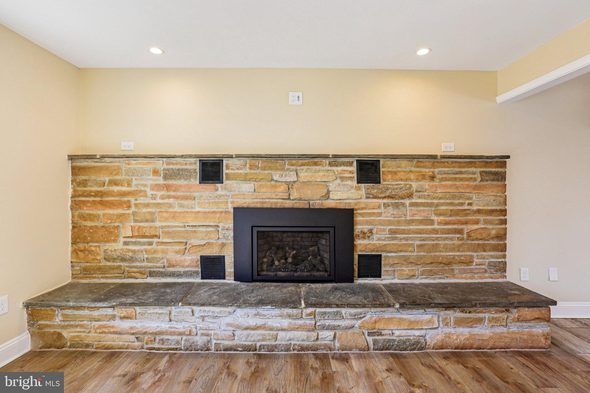 306 Christy Road Pasadena, MD 21122 - Photo 5 of 58 Elegant stone fireplace as a focal point.