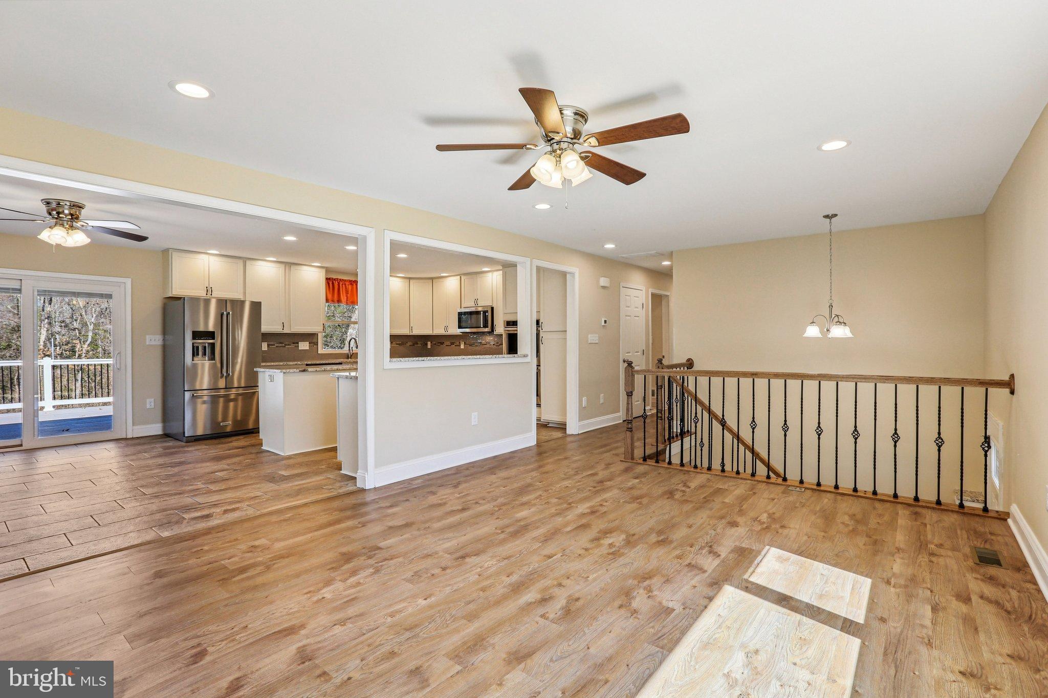 306 Christy Road Pasadena, MD 21122 - Photo 6 of 58 a view of a electric appliances in kitchen and empty room with wooden floor