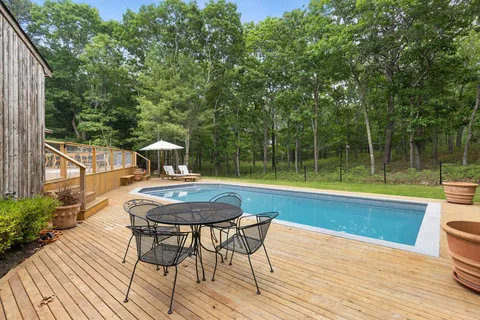 a view of a swimming pool with a table and chairs