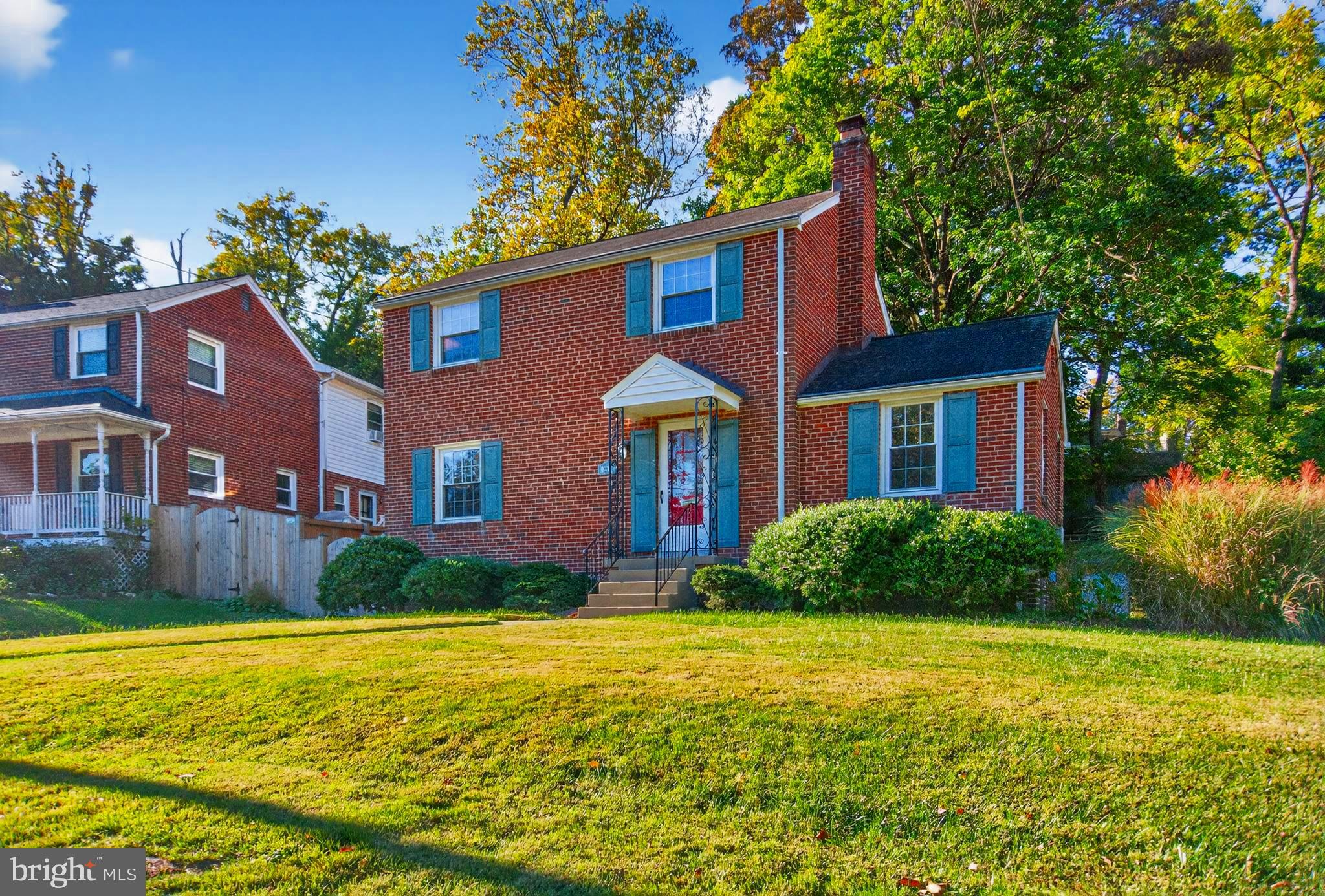 10018 Brookmoor Drive Silver Spring, MD 20901 - Photo 1 of 22 a front view of a house with garden
