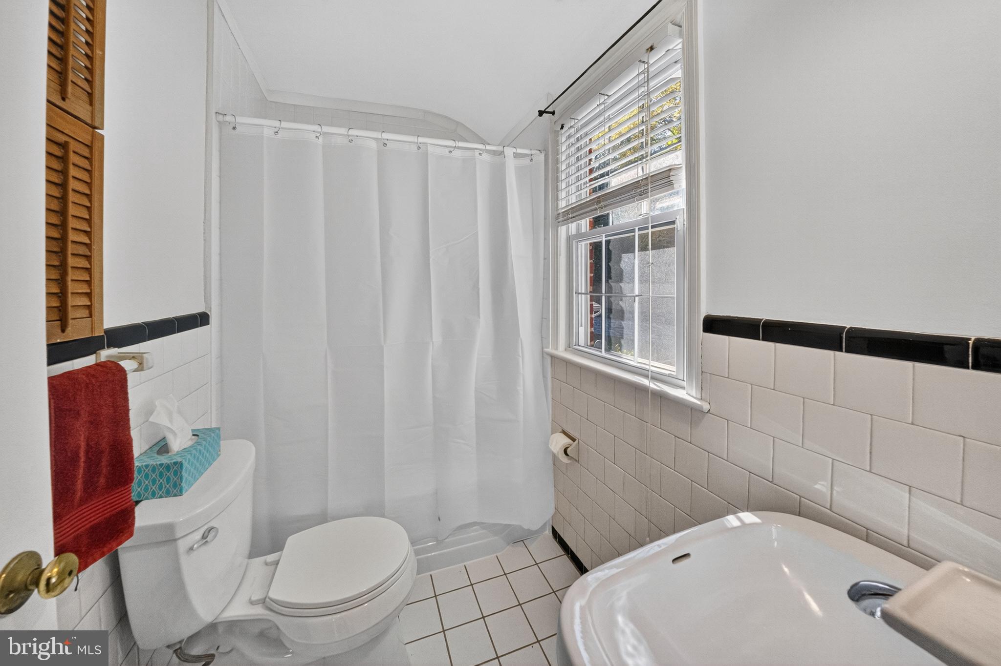 10018 Brookmoor Drive Silver Spring, MD 20901 - Photo 16 of 22 a bathroom with a toilet a sink and a shower