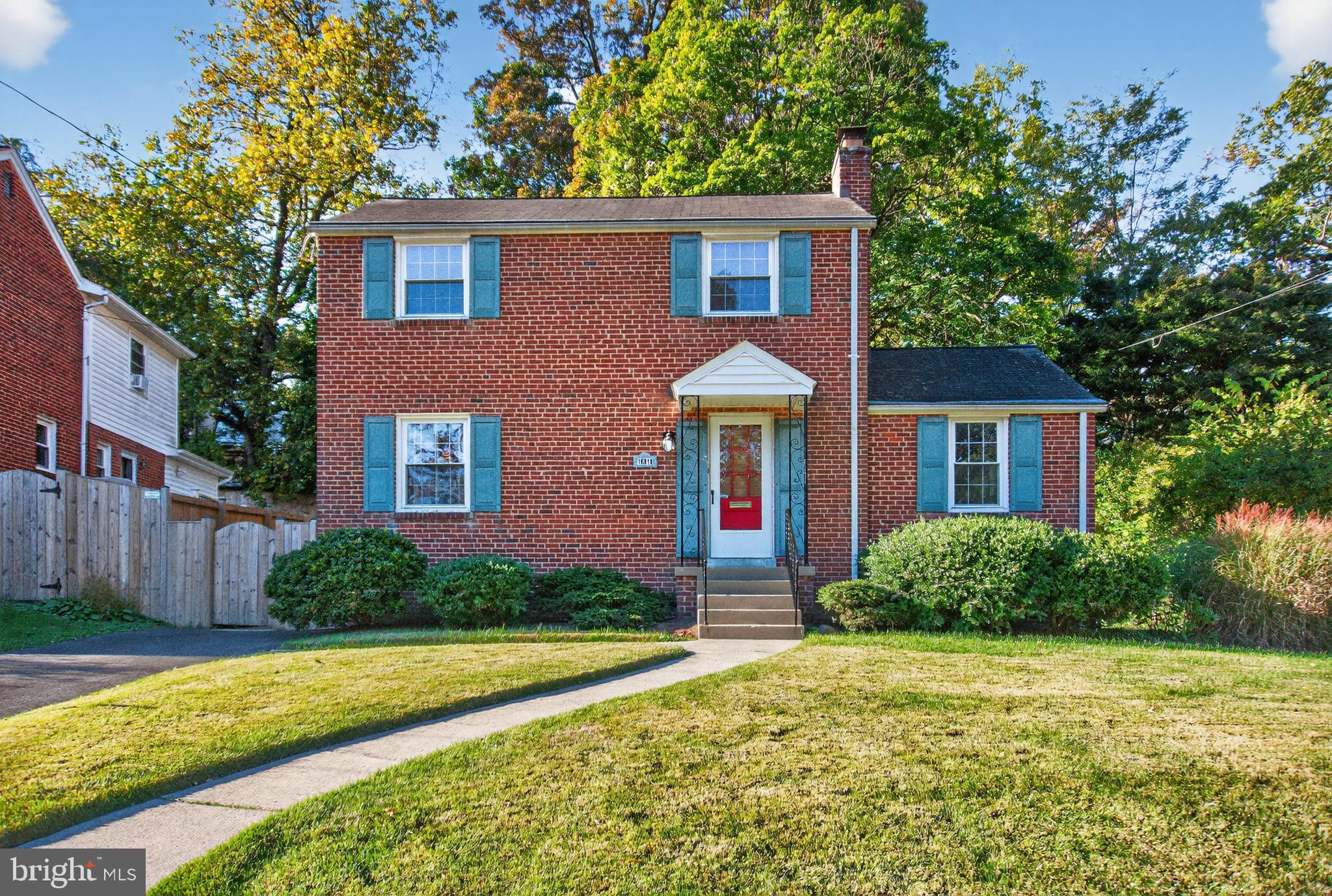 10018 Brookmoor Drive Silver Spring, MD 20901 - Photo 3 of 22 a front view of a house with a yard and garage
