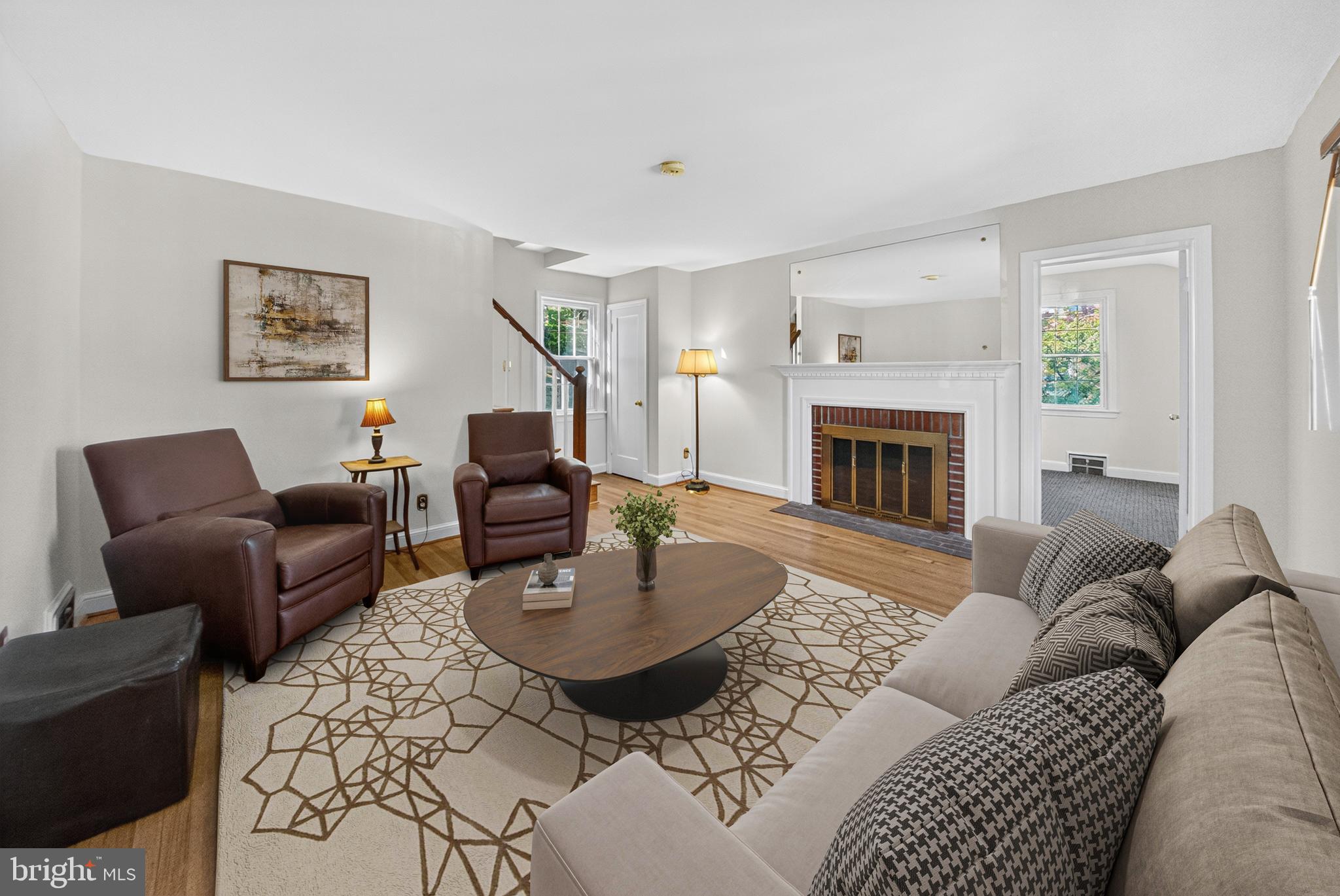 10018 Brookmoor Drive Silver Spring, MD 20901 - Photo 4 of 22 a living room with furniture a fireplace and a table