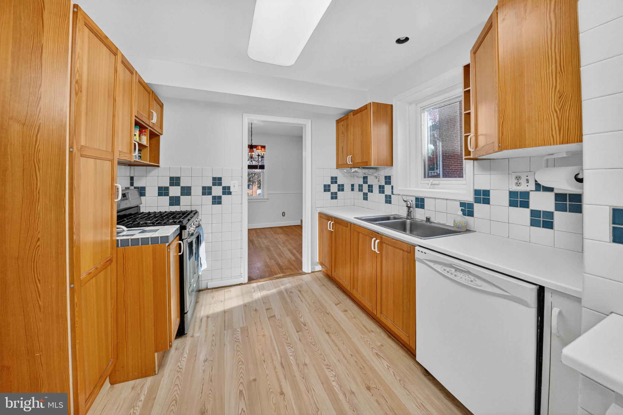 10018 Brookmoor Drive Silver Spring, MD 20901 - Photo 6 of 22 a kitchen with stainless steel appliances a sink cabinets and wooden floor