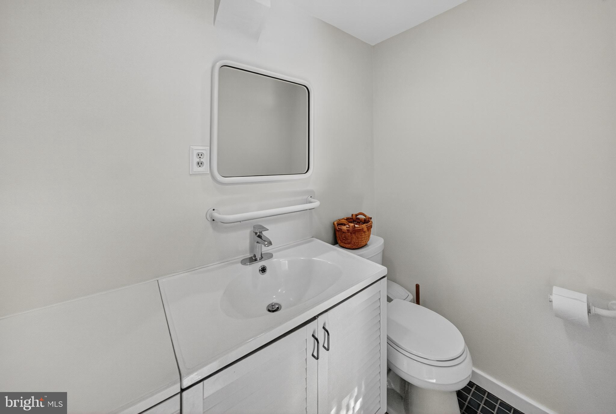 10018 Brookmoor Drive Silver Spring, MD 20901 - Photo 10 of 22 a bathroom with a toilet sink and mirror