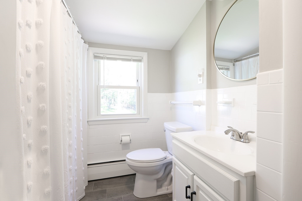 15 Davidson Road Framingham, MA 01701 - Photo 19 of 33 a bathroom with a sink a toilet and a mirror
