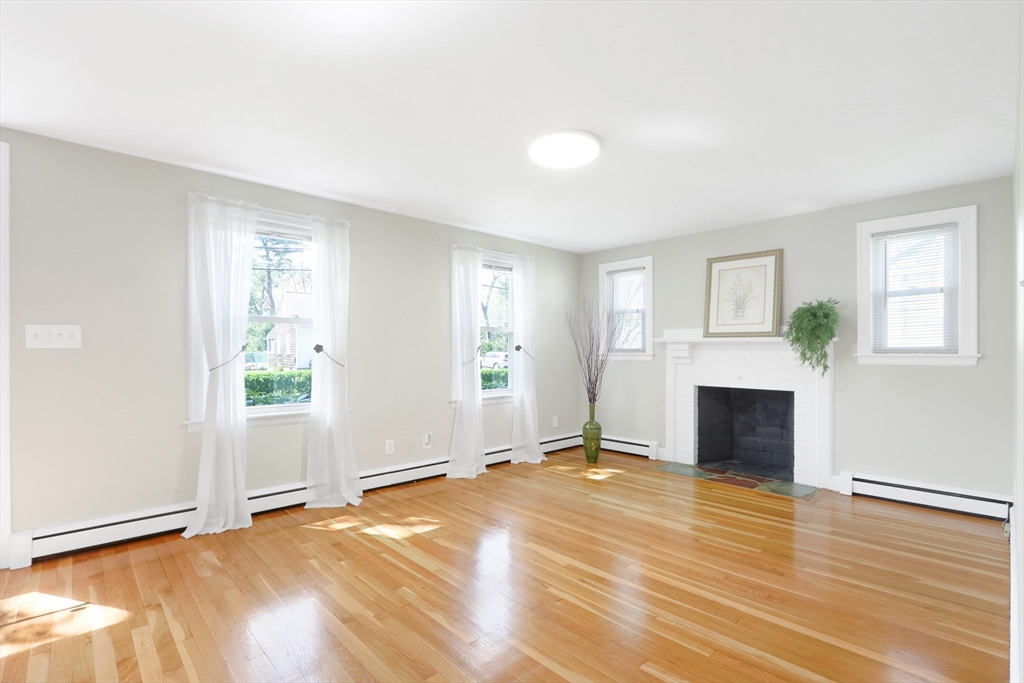 15 Davidson Road Framingham, MA 01701 - Photo 2 of 33 an empty room with windows and a fireplace