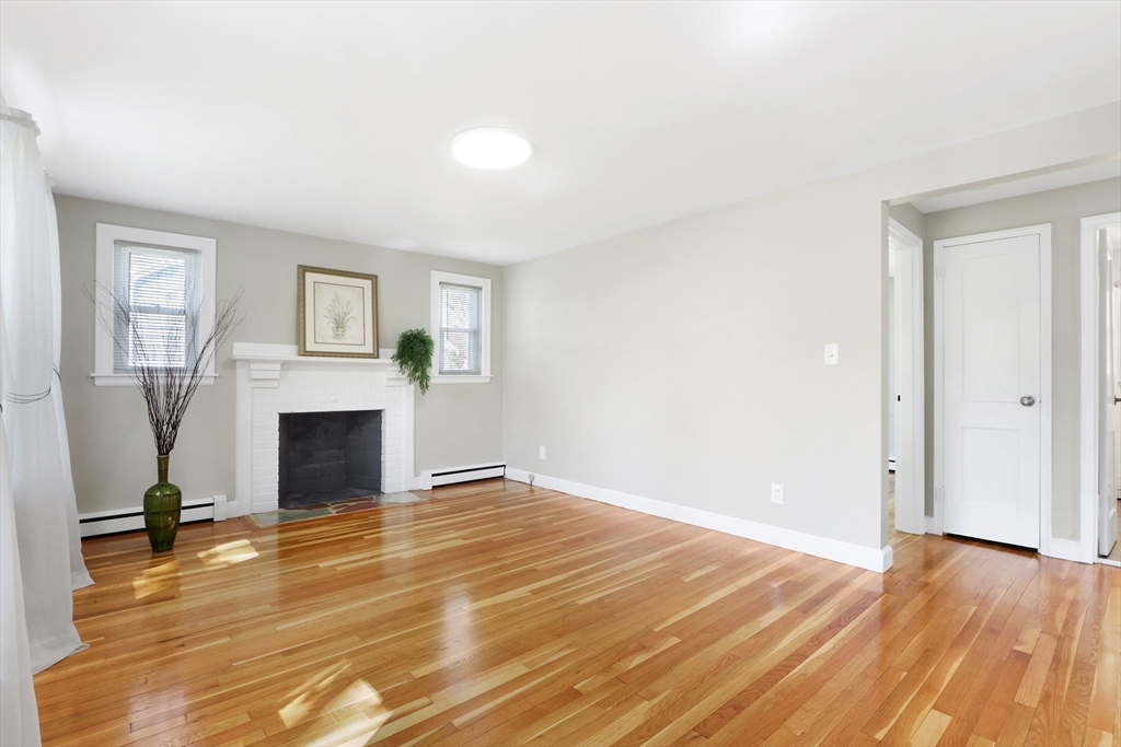 15 Davidson Road Framingham, MA 01701 - Photo 3 of 33 a view of empty room with fireplace and wooden floor