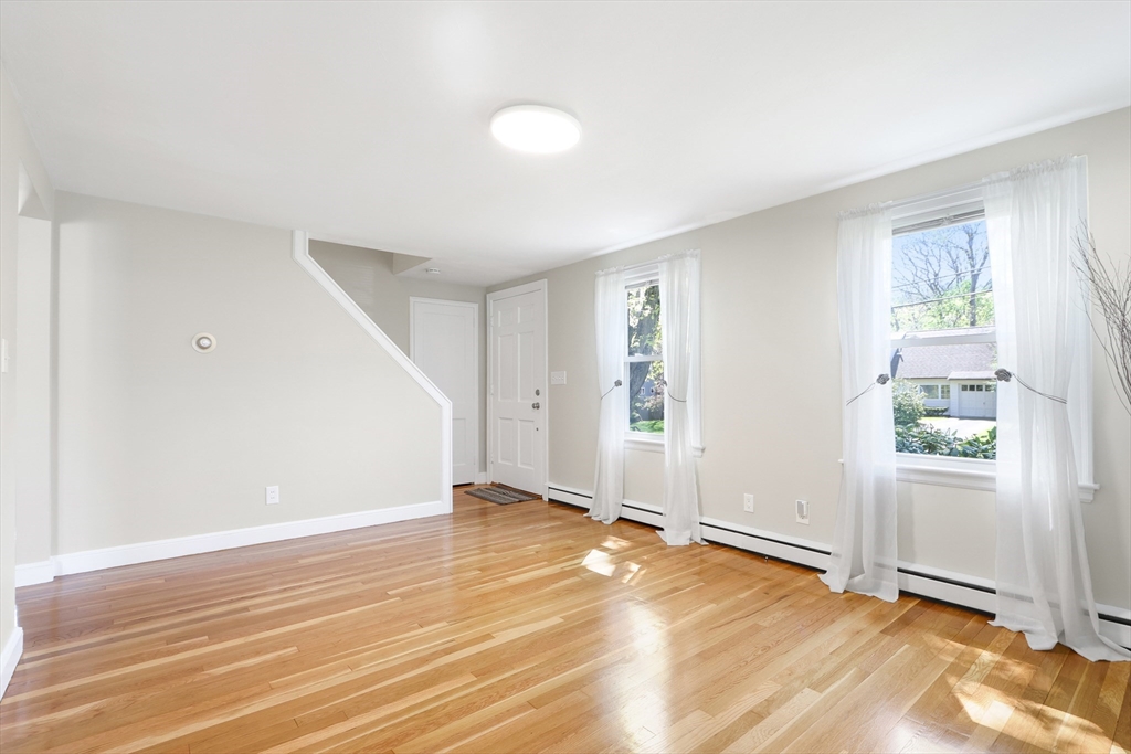 15 Davidson Road Framingham, MA 01701 - Photo 4 of 33 an empty room with wooden floor and windows