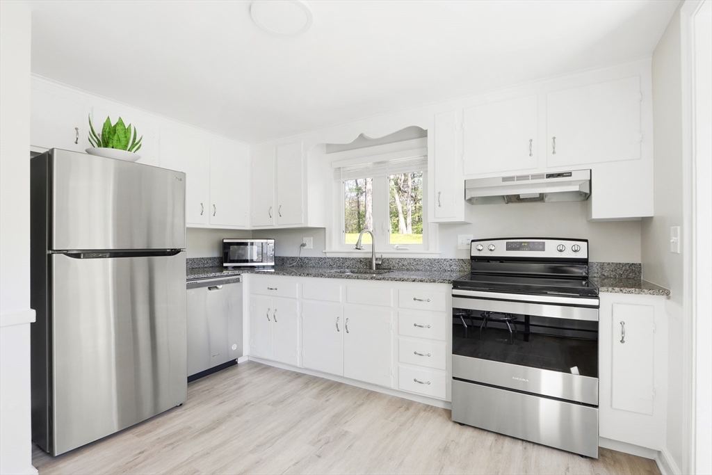 15 Davidson Road Framingham, MA 01701 - Photo 5 of 33 a kitchen with white cabinets and white appliances