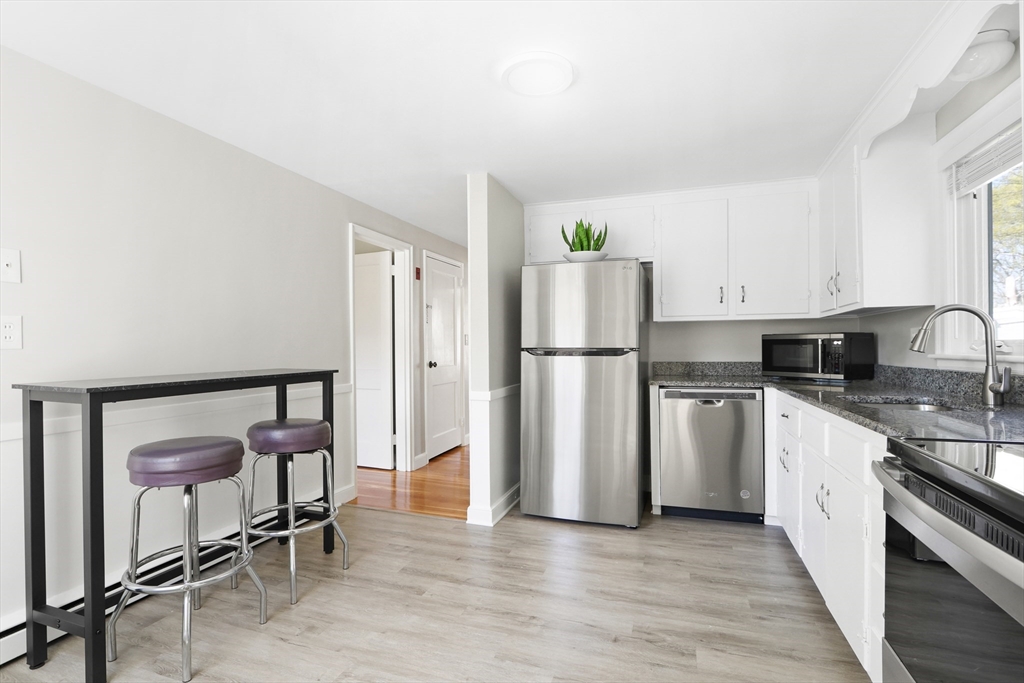 15 Davidson Road Framingham, MA 01701 - Photo 6 of 33 a kitchen with a refrigerator and a stove top oven