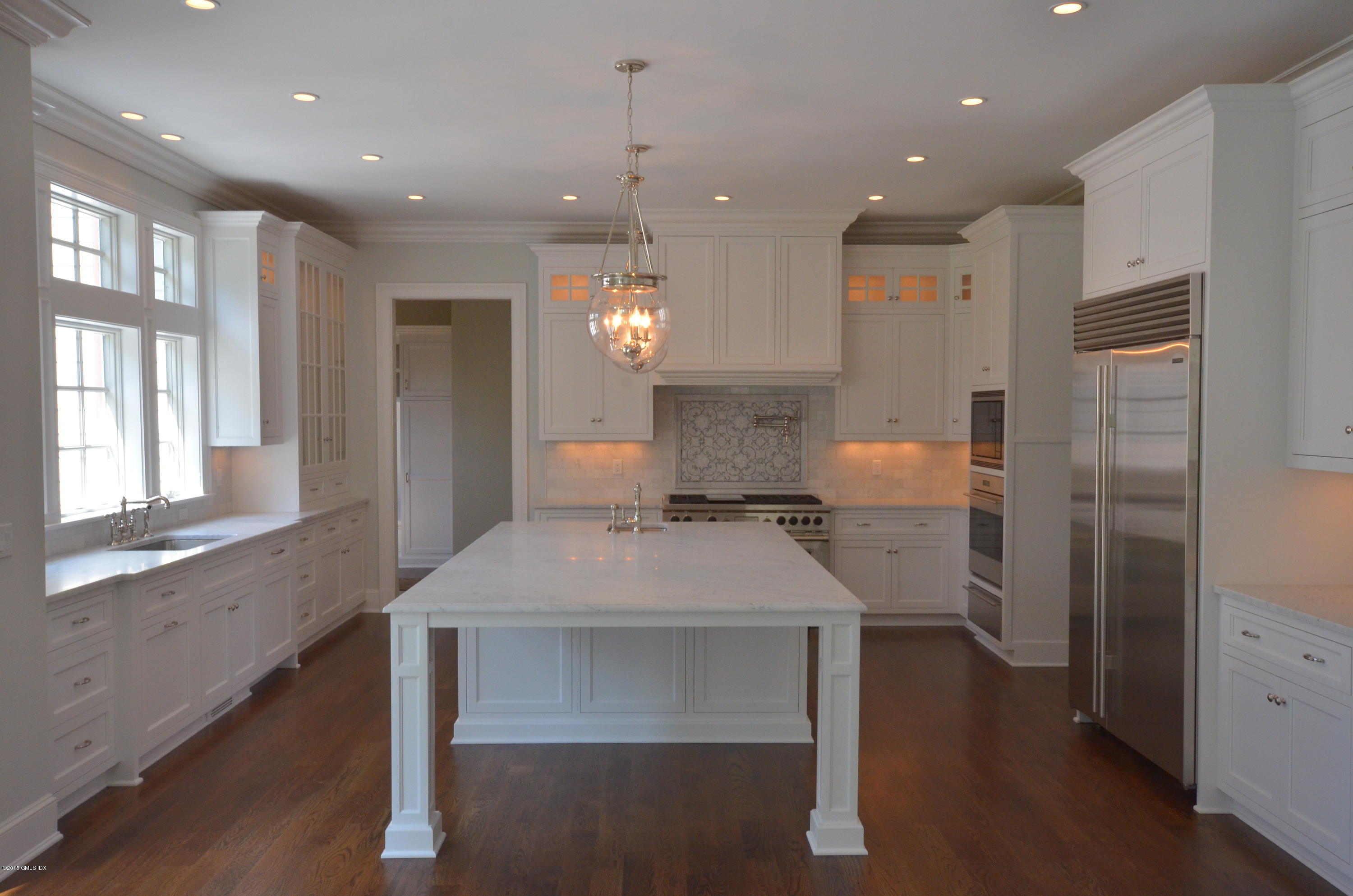 29 Winthrop Drive Riverside, CT 06878 - Photo 4 of 9 a kitchen with a table chairs refrigerator and microwave
