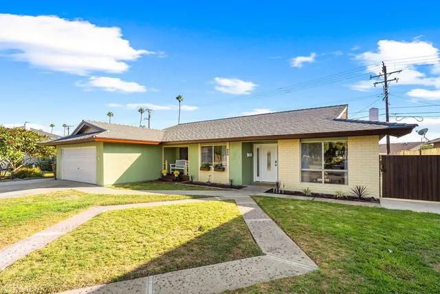 a view of a house with a swimming pool and sitting area