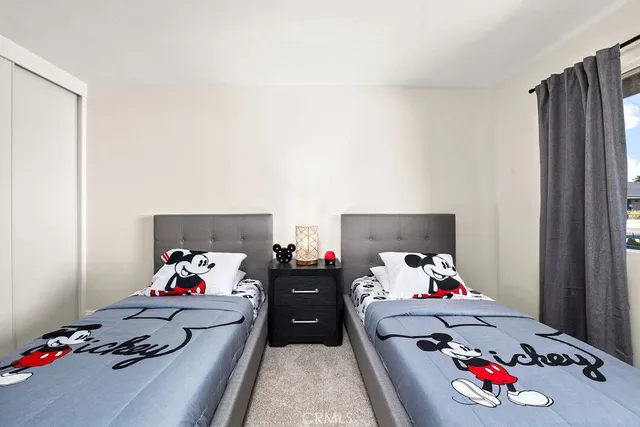 a bedroom with a baby bed and a couch