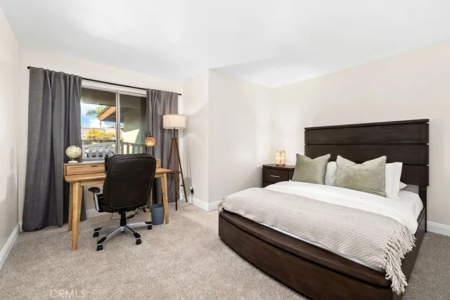 a bedroom with a bed and a desk