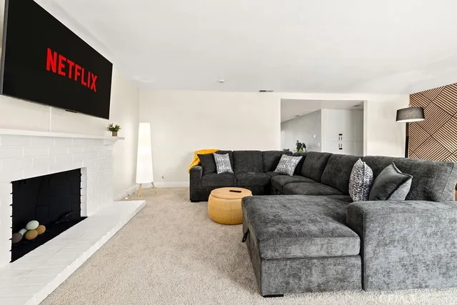 a living room with furniture and a fireplace