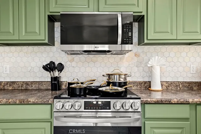 a kitchen with stove and cabinets