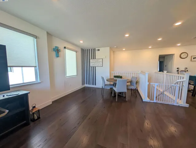 a dining room with furniture and wooden floor