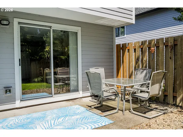 a patio with table and chairs