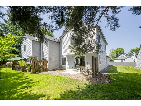 a house view with swimming pool and garden space