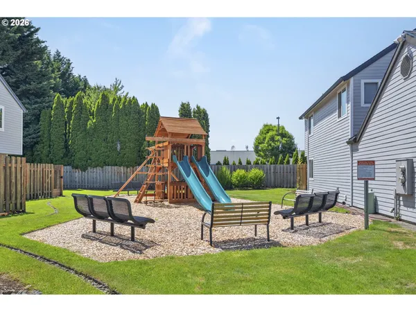 a view of a house with backyard and a slide