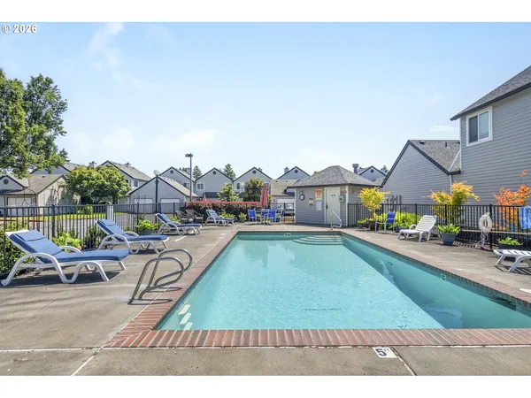 a swimming pool with outdoor seating and yard