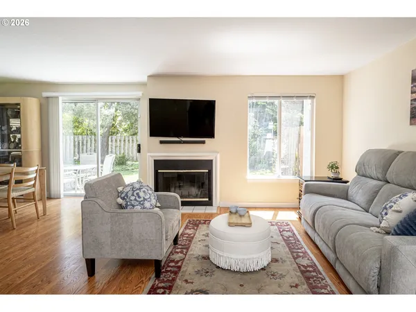 a living room with furniture a flat screen tv and a fireplace